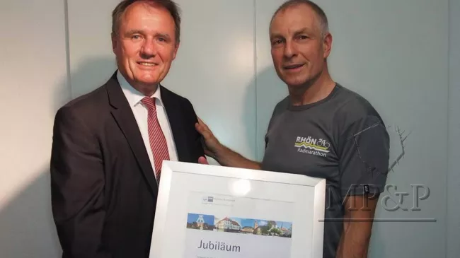 Christoph Burghaus (IHK) überreicht Martin Poettgen die Urkunde des 25-jährigen Betriebsjubiläums